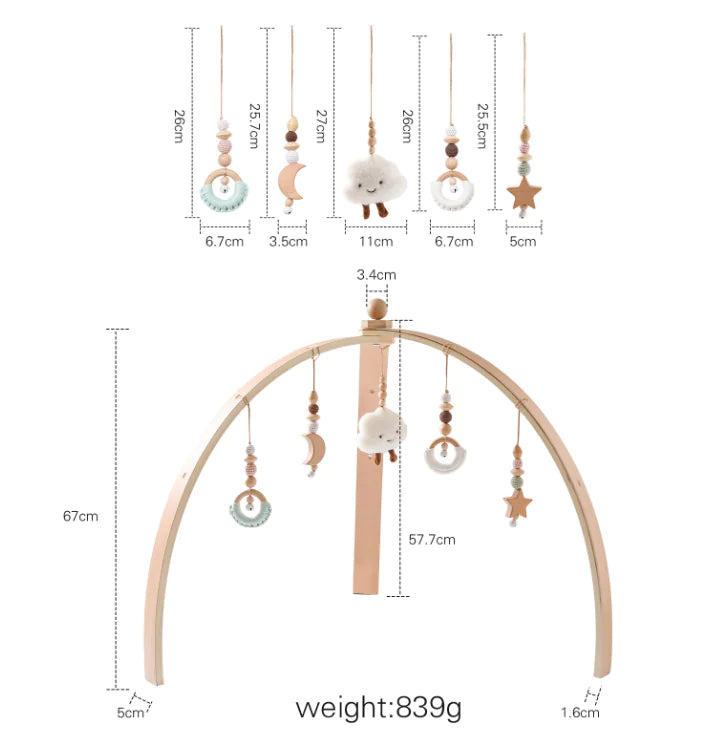 Wooden baby mobile with hanging elements and measurements on a white background