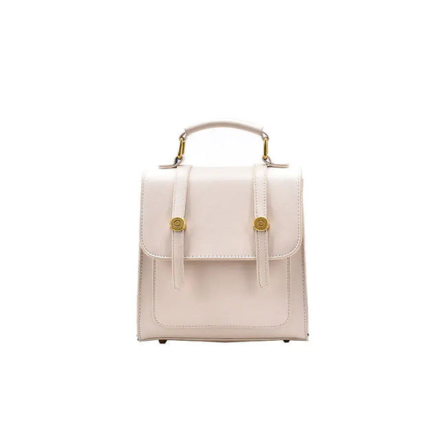 Small beige handbag with gold accents on a white background