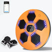 Orange exercise board with black hexagonal pads and LED lights, accompanied by boxing gloves on a white background.