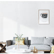 Living room with a gray sofa, decorative pillows, and a framed picture on the wall.
