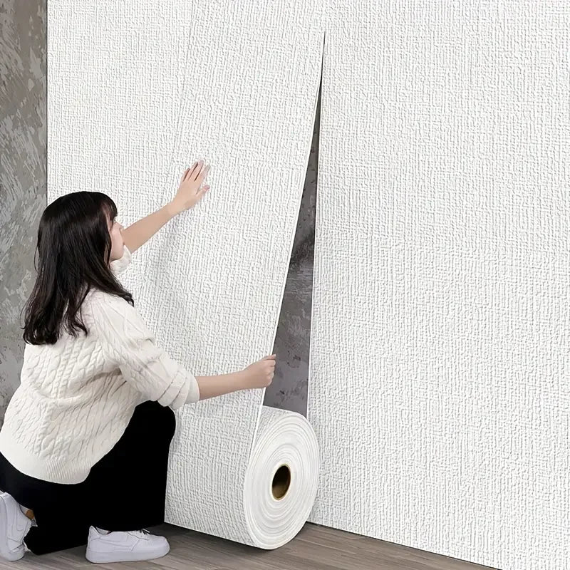 Person unrolling wallpaper in a room