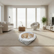 Fluffy pet bed with gray exterior and white interior on a white background
