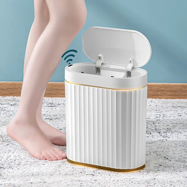 White electronic device with a wireless charging pad on a textured surface, with a person's leg in the background.