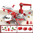 Toy fire station with airplane, crane, and accessories on a wooden surface.