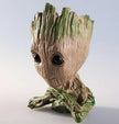 Tree-like character with large eyes on a light gray background