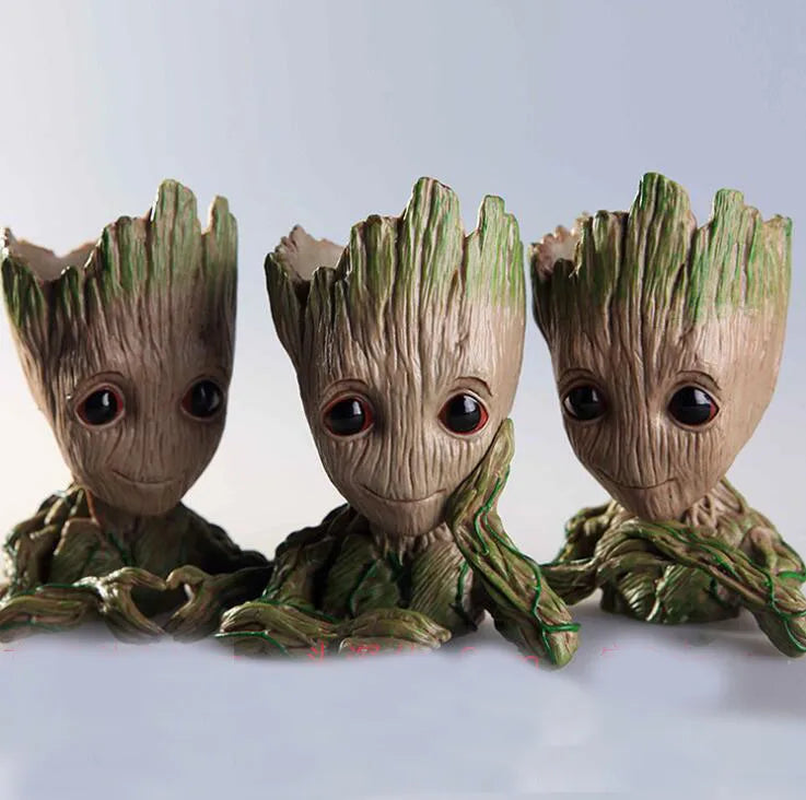 Three Groot figurines from Guardians of the Galaxy on a light gray background