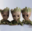 Three Groot figurines from Guardians of the Galaxy on a light gray background