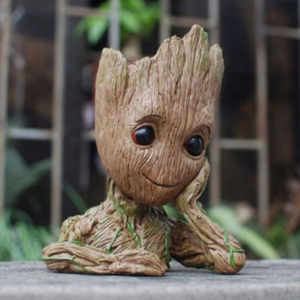 Small tree-like figurine with a smiling face on a blurred natural background