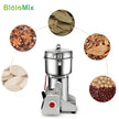 BioloMix spice grinder with various spices around it on a white background