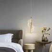 Modern pendant light fixture in a bedroom setting with a neutral color scheme.