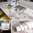 Marble-patterned countertop with sink, followed by images of the product packaging.