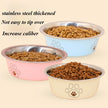 Three stainless steel pet bowls filled with kibble on a beige background