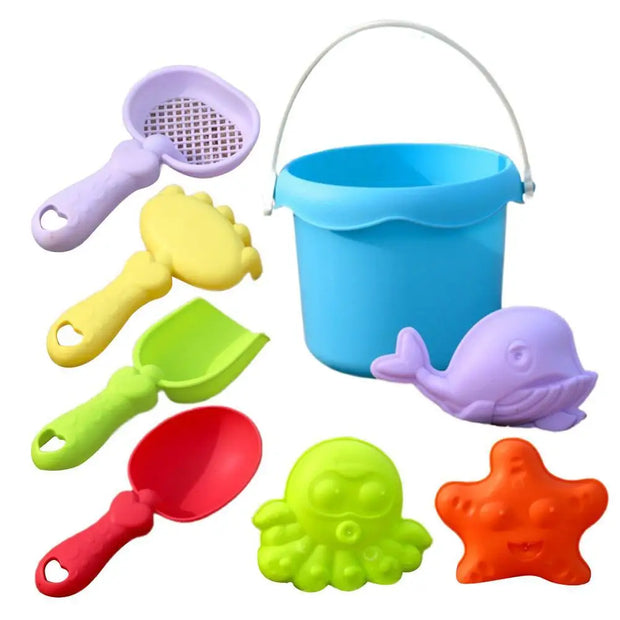 Set of colorful sand toys including a bucket, shovels, and molds on a white background