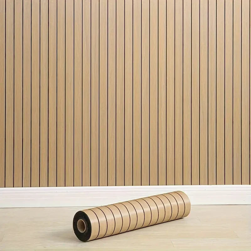 Roll of wooden flooring against a wooden panel wall.