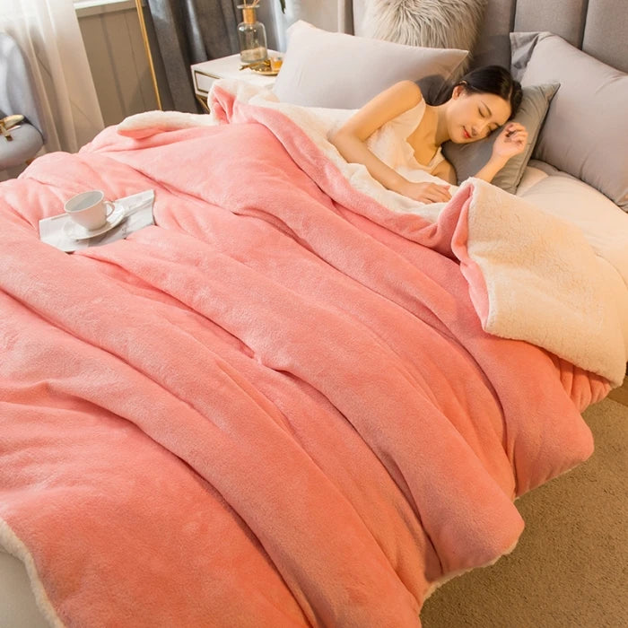 Woman sleeping under a pink blanket on a bed with a cup and saucer on a nightstand.