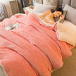 Woman sleeping under a pink blanket on a bed with a cup and saucer on a nightstand.