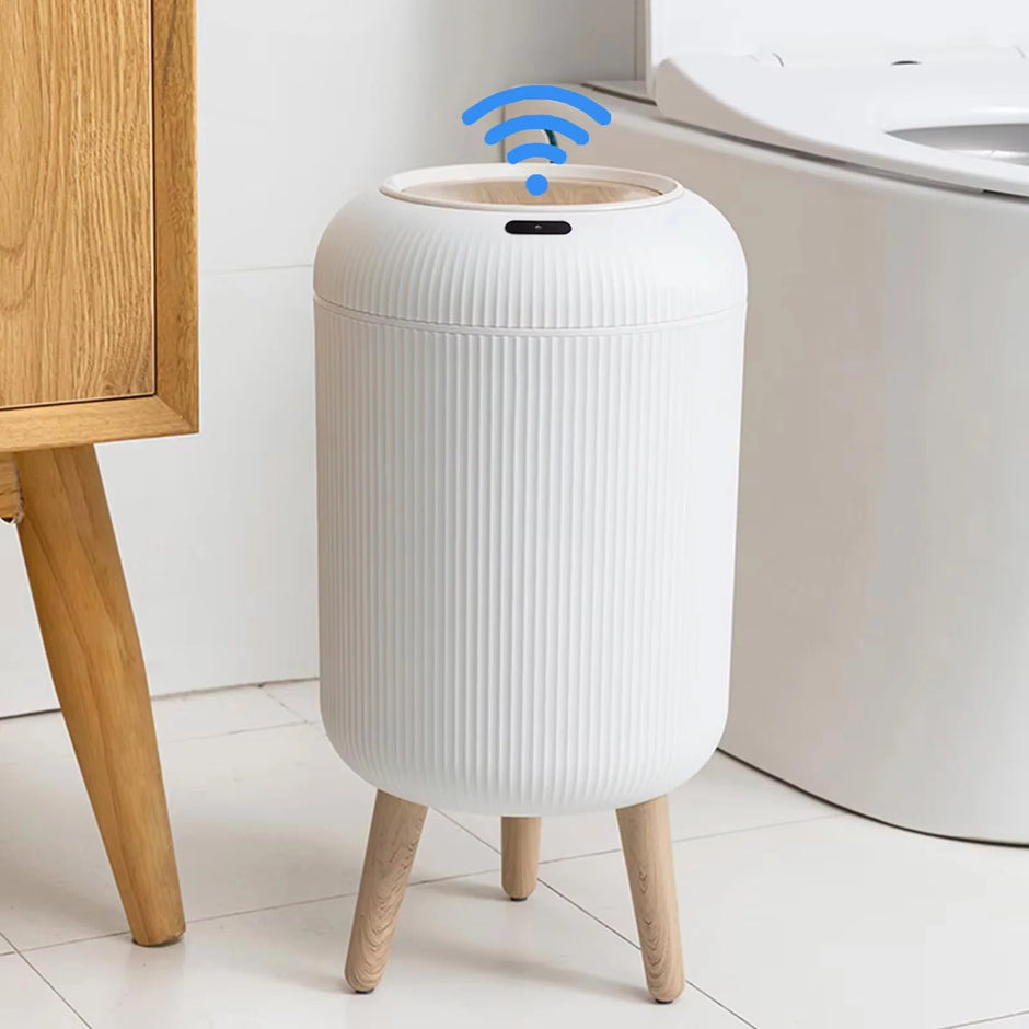 White trash bin with wooden legs in a bathroom setting