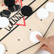 Hand placing a white disc on a game board with black and red markings