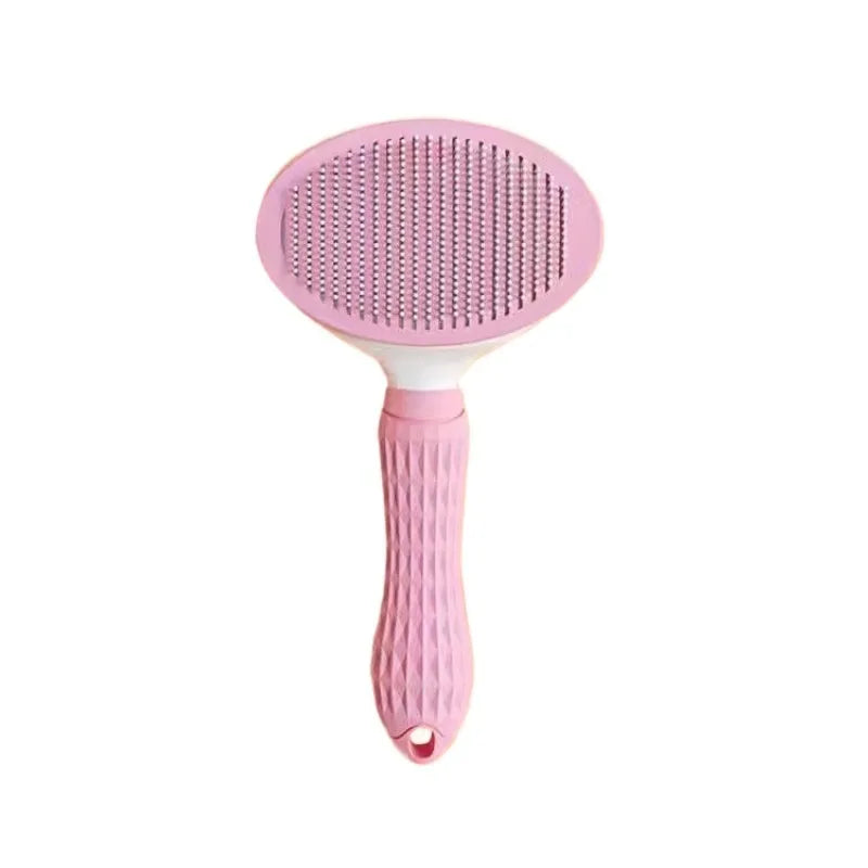 Pink pet grooming brush on a white background