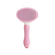 Pink pet grooming brush on a white background