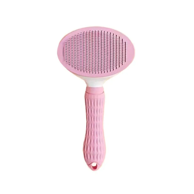 Pink pet grooming brush on a white background