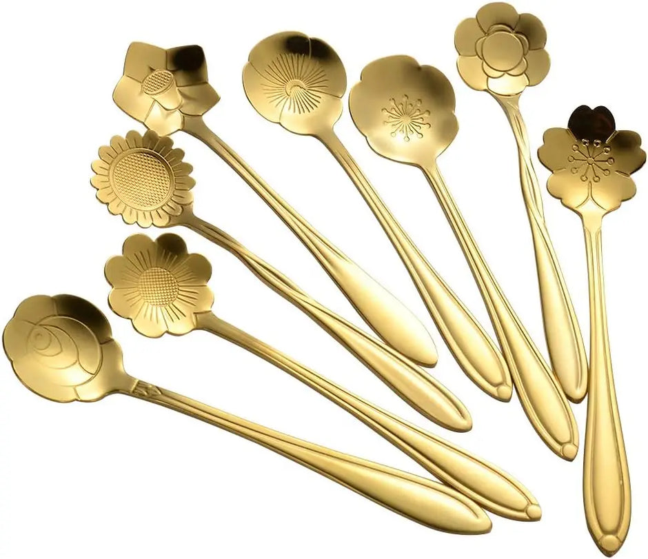 Set of gold floral spoons on a white background