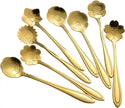 Set of gold floral spoons on a white background