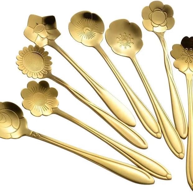 Set of gold floral spoons on a white background