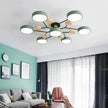 Modern living room with a stylish ceiling light fixture, gray sofa, and decorative elements.