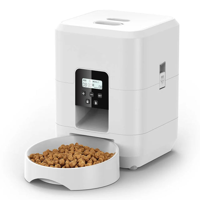 White pet food dispenser with a digital display and a bowl of kibble on a white background