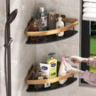 Gold corner shower caddy with various bottles on a tiled shower wall.