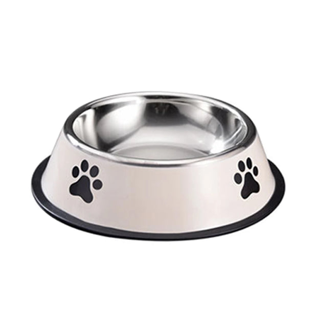Stainless steel dog bowl with black paw prints on a white background