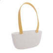 White handbag with yellow handles on a white background