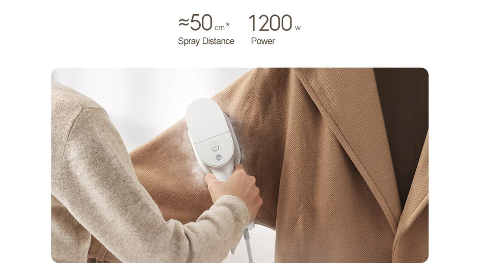 Person using a handheld garment steamer on a coat with text indicating spray distance and power.