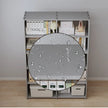 Bookshelf with a round mirror on top displaying water droplets.