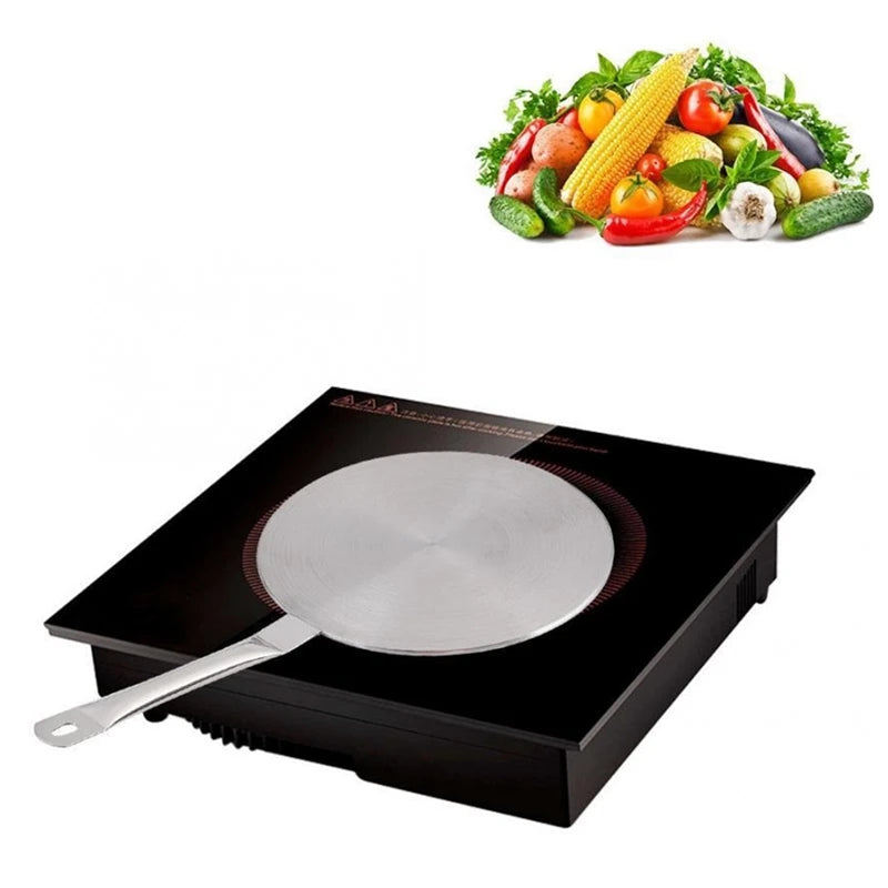 Induction cooktop with a frying pan on a white background, accompanied by an inset of vegetables.