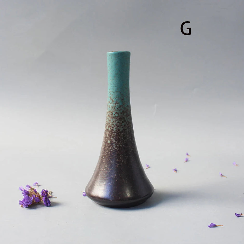 Cylindrical vase with gradient color from green to brown on a gray background