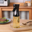 Oil spray bottle with oil on a wooden surface in a kitchen setting