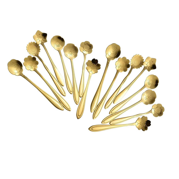 Set of gold floral spoons on a white background