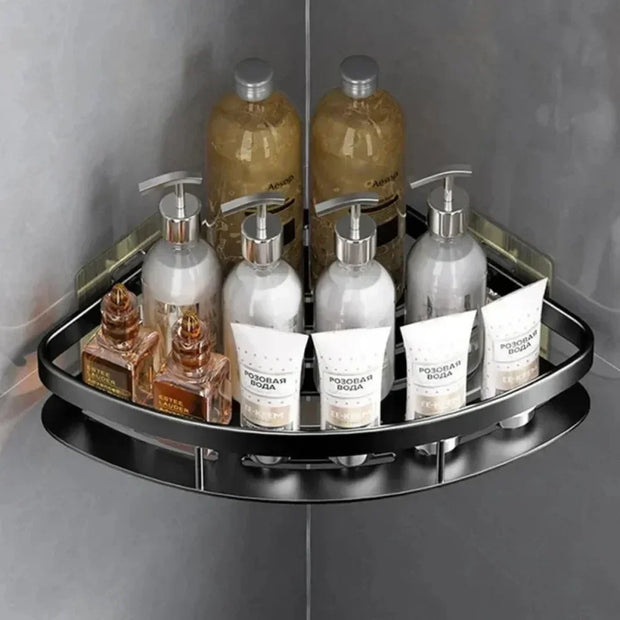 Corner shower caddy with various bottles and containers on a gray tiled wall background