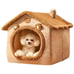 Small white dog inside a beige pet house with a teddy bear design on a white background