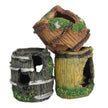Three decorative aquarium plants resembling wooden barrels with moss on a white background
