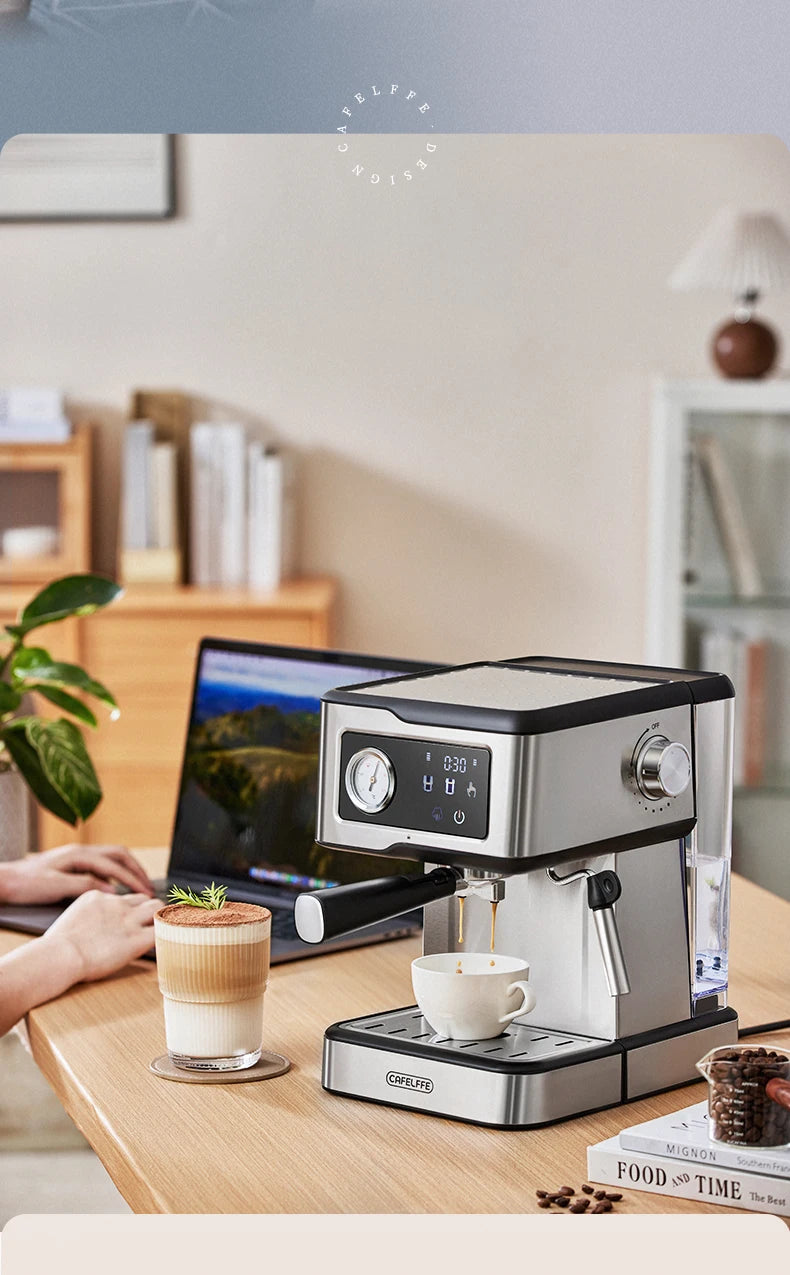 Espresso machine on a wooden desk with a laptop and coffee cup in a home office setting.