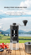 Black manual coffee grinder on a wooden table with a scenic background