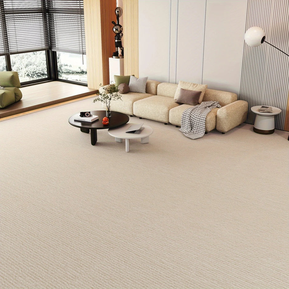 Modern living room with a beige sectional sofa and light gray carpet.