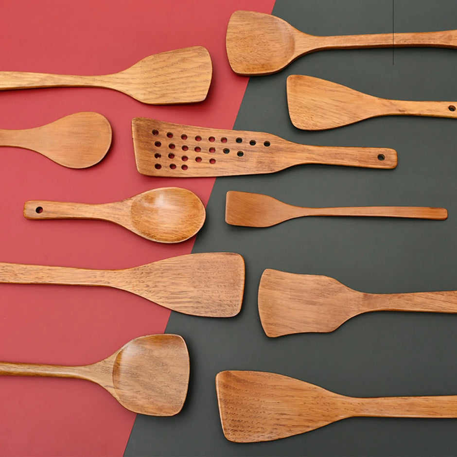 Set of wooden cooking utensils on a two-tone red and gray background
