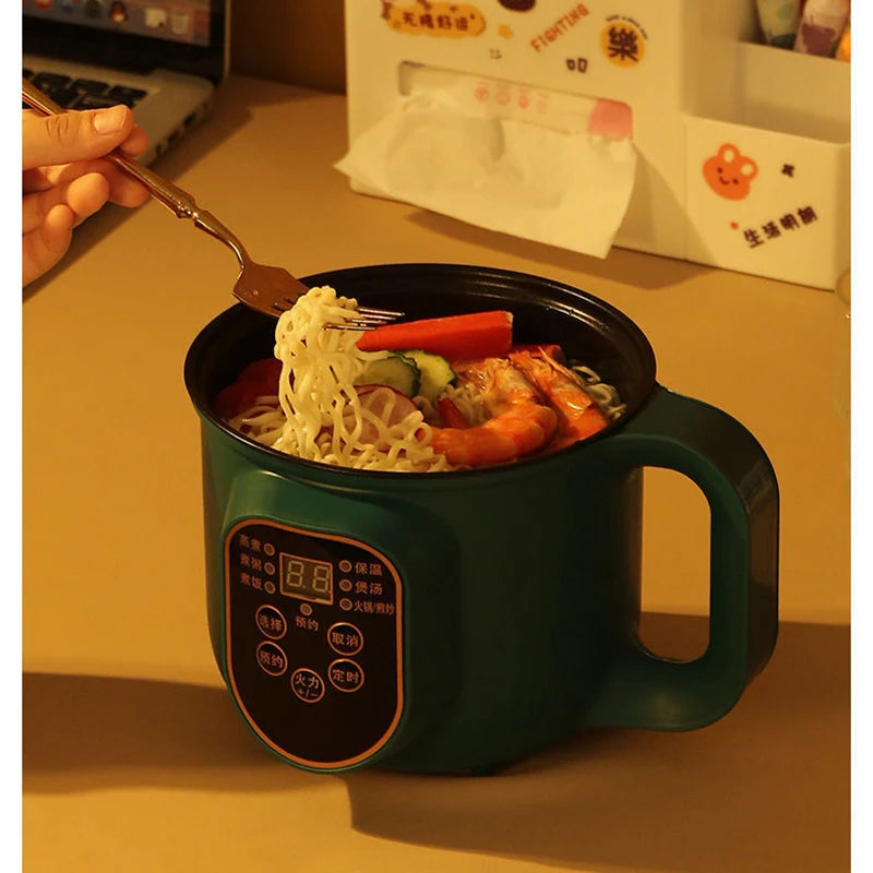 Noodles with vegetables in a green electric mug on a desk