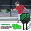 Boy holding a pickleball paddle on a court with pickleballs and paddles displayed.