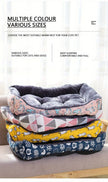 Stack of pet beds in various colors and patterns on a white background