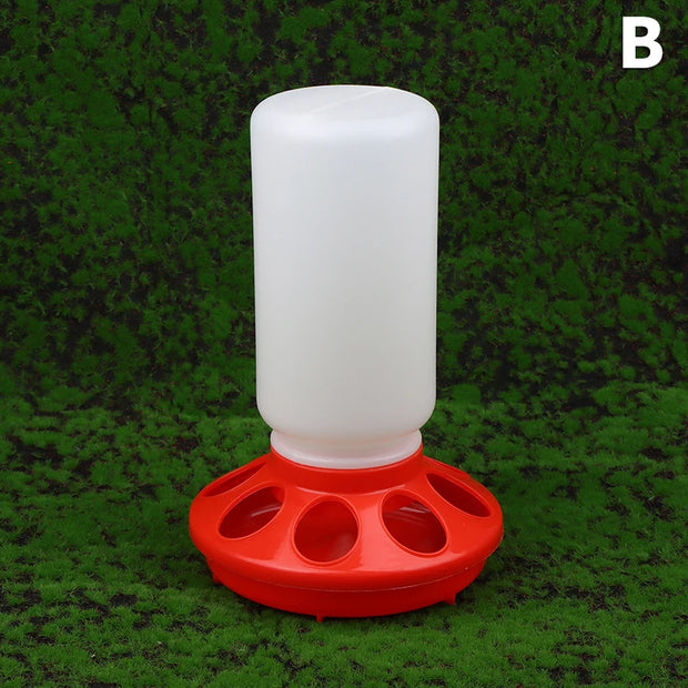 White plastic feeder with red base on a green grass background
